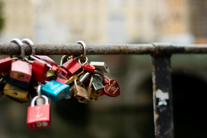 Several locks attached to a metal rail.